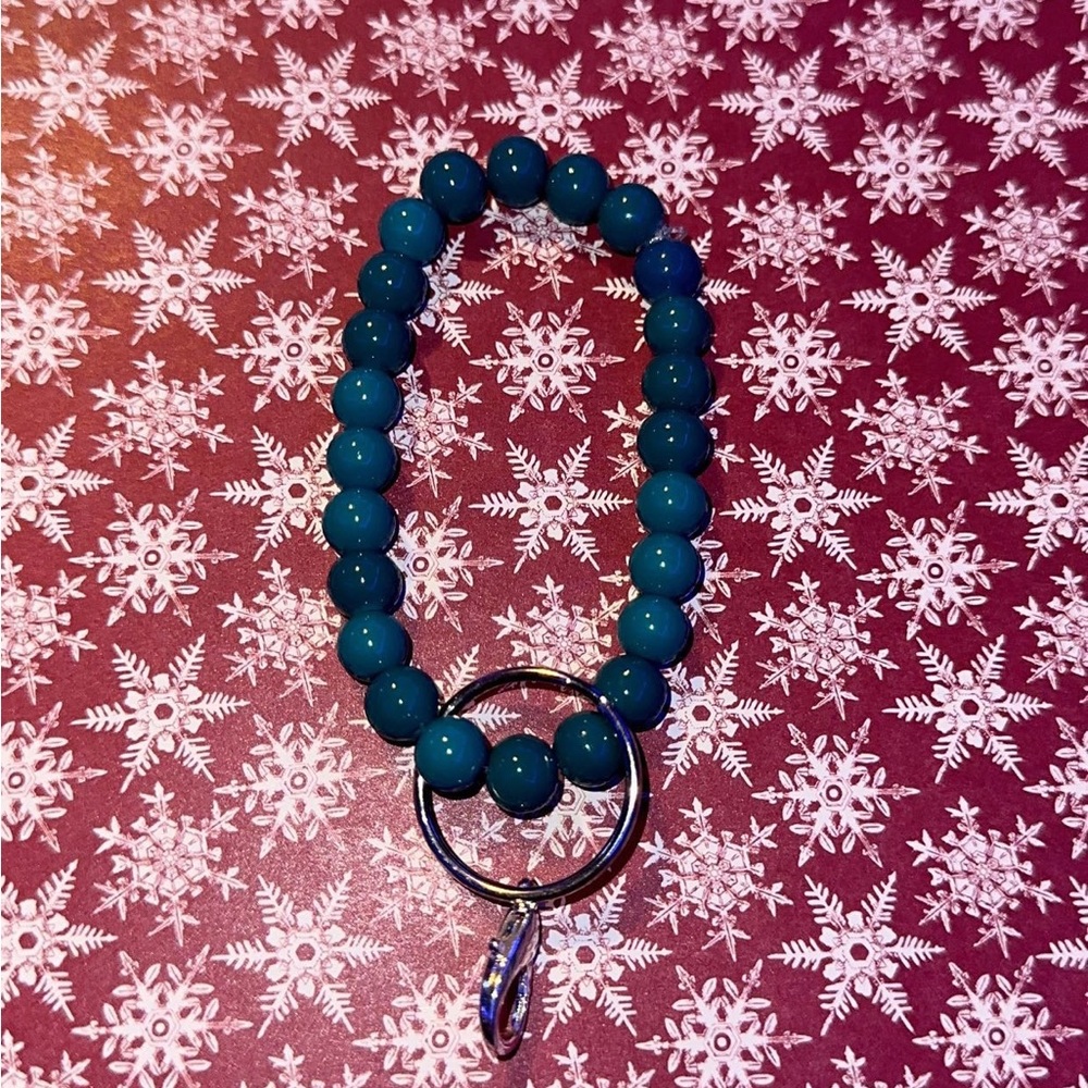 green/blue ish wristlet holds you’re keys, handsantizer, anything!